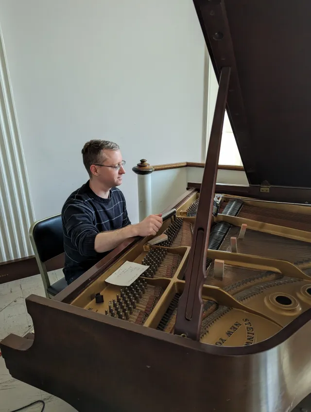 Matthew Ward tuning a Steinway grand piano